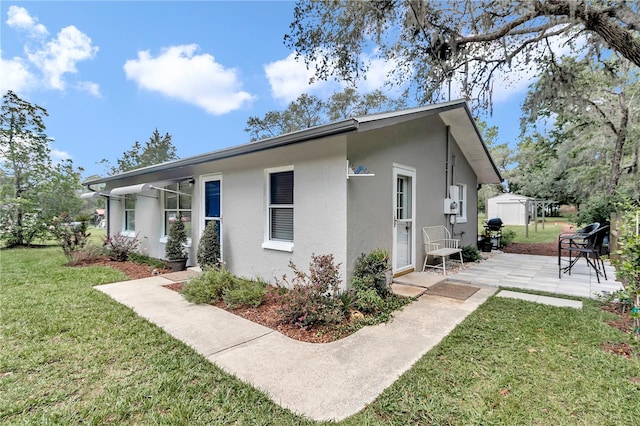 exterior space featuring a yard and a patio