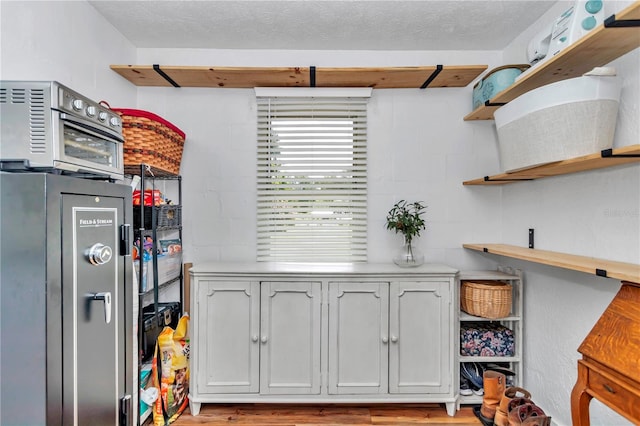 kitchen with a textured ceiling and refrigerator