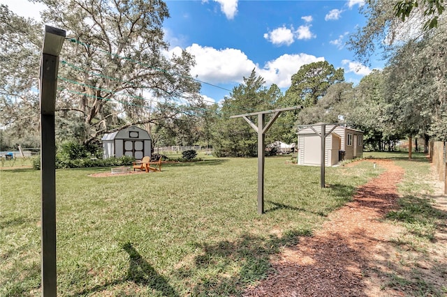 view of yard with a storage shed and a fire pit