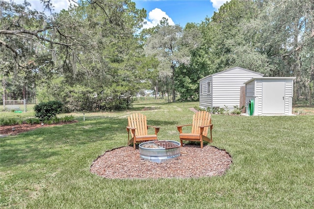 view of yard with an outdoor fire pit and a storage unit