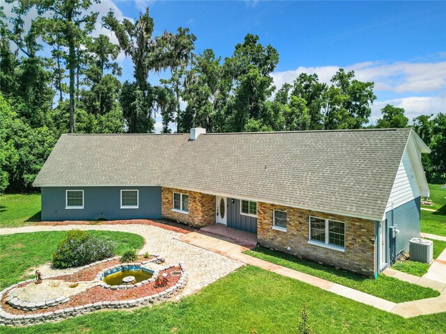 single story home featuring a patio, central AC, and a front yard