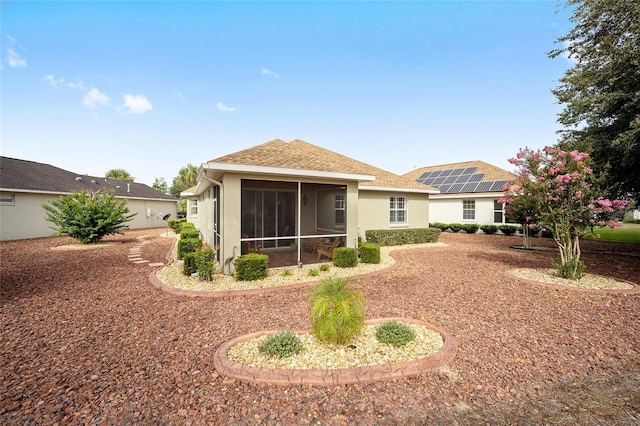 back of property with a sunroom