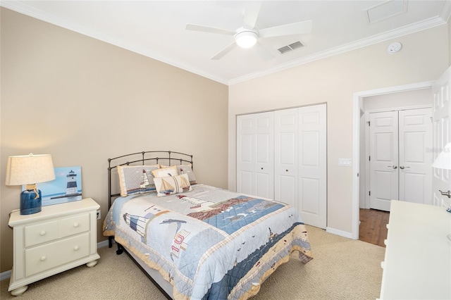 carpeted bedroom with a closet, ceiling fan, and crown molding