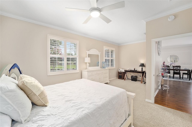 bedroom featuring ceiling fan, carpet, and ornamental molding