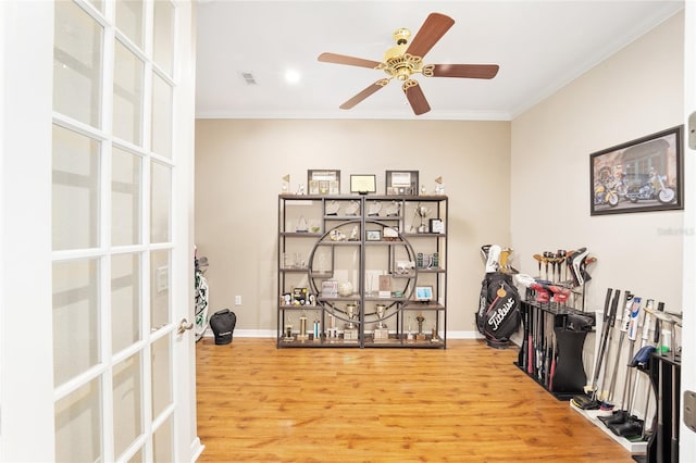 home office with hardwood / wood-style floors, ceiling fan, and crown molding