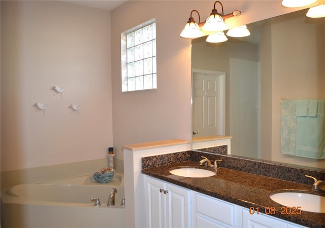 bathroom with a washtub and vanity