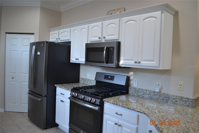 kitchen featuring crown molding, light stone countertops, light tile patterned floors, white cabinetry, and stainless steel appliances