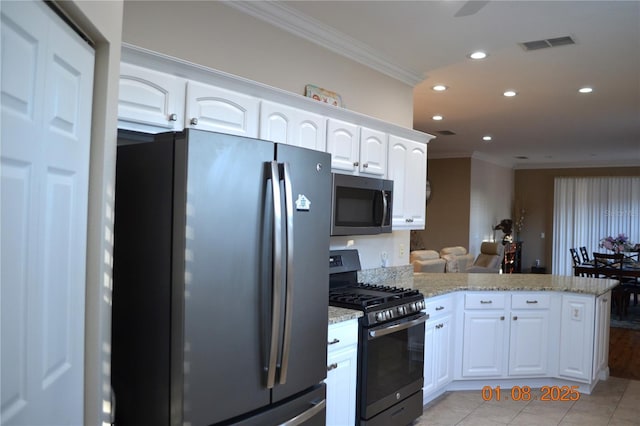 kitchen with white cabinets, stainless steel appliances, kitchen peninsula, and light stone countertops