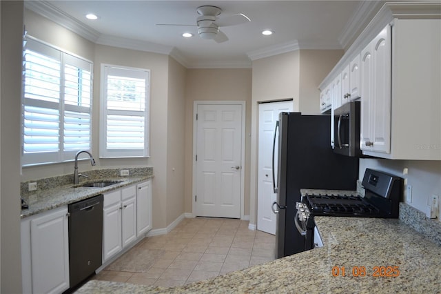 kitchen with light stone countertops, white cabinetry, sink, and appliances with stainless steel finishes