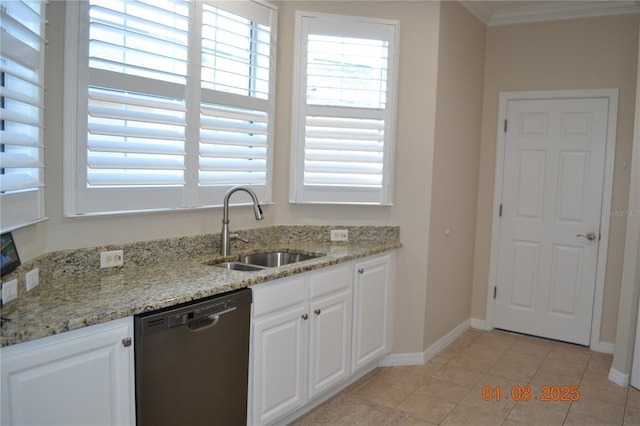 kitchen featuring light stone countertops, sink, light tile patterned floors, stainless steel dishwasher, and white cabinets