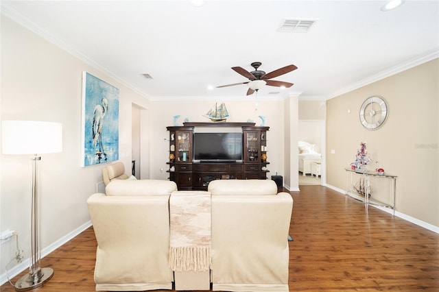 living room featuring dark hardwood / wood-style floors, ceiling fan, and ornamental molding