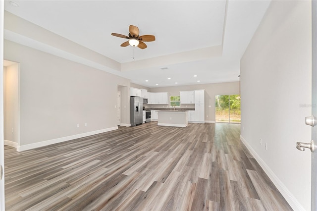 4444 SW 118th Ter, Ocala, FL 34481 - unfurnished living room featuring a ceiling fan, light wood-type flooring, baseboards, and recessed lighting