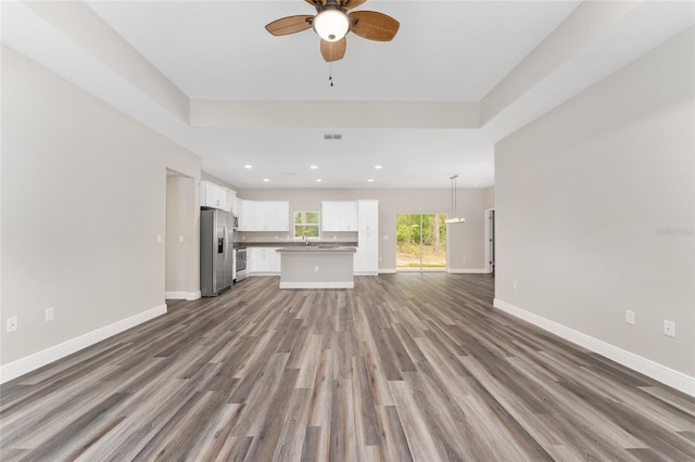 4444 SW 118th Ter, Ocala, FL 34481 - unfurnished living room with ceiling fan, baseboards, wood finished floors, recessed lighting, and a sink