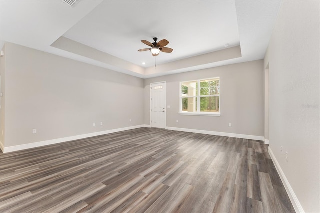 4444 SW 118th Ter, Ocala, FL 34481 - empty room featuring ceiling fan, a raised ceiling, dark wood-style flooring, and baseboards