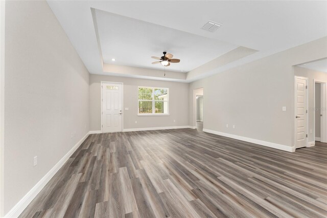 4444 SW 118th Ter, Ocala, FL 34481 - unfurnished living room featuring ceiling fan, a tray ceiling, dark wood-style floors, baseboards, and recessed lighting