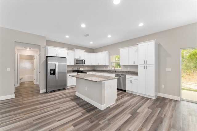 4444 SW 118th Ter, Ocala, FL 34481 - kitchen featuring appliances with stainless steel finishes, light wood finished floors, healthy amount of natural light, white cabinetry, and recessed lighting