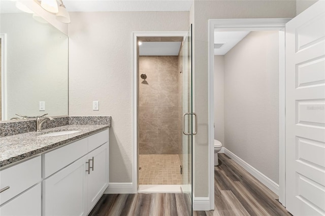 4444 SW 118th Ter, Ocala, FL 34481 - bathroom featuring wood finished floors, a shower stall, vanity, and toilet