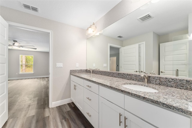4444 SW 118th Ter, Ocala, FL 34481 - full bathroom featuring wood finished floors, baseboards, double vanity, and a ceiling fan
