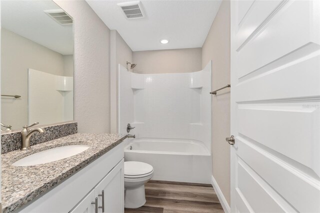 4444 SW 118th Ter, Ocala, FL 34481 - bathroom featuring wood finished floors, toilet, vanity, washtub / shower combination, and recessed lighting
