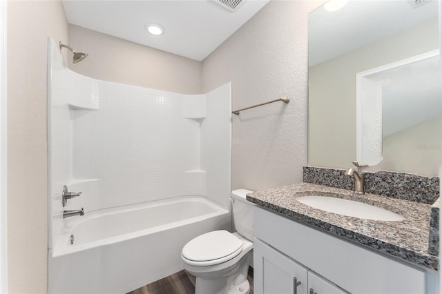 4444 SW 118th Ter, Ocala, FL 34481 - bathroom featuring wood finished floors, toilet, shower / washtub combination, vanity, and a textured wall
