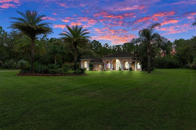 mediterranean / spanish-style house featuring a lawn