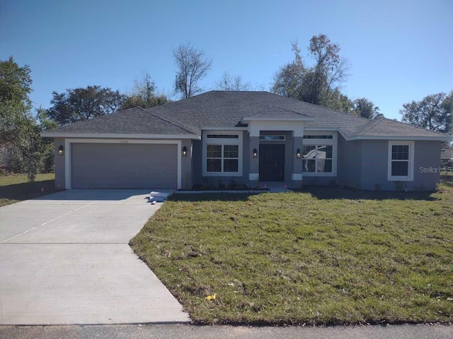 ranch-style home with a front lawn and a garage