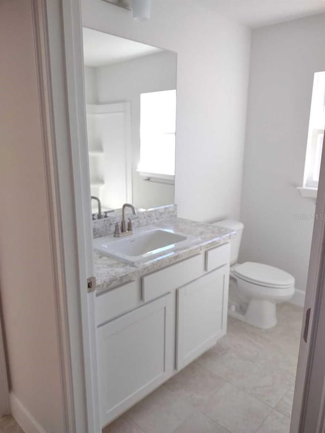 bathroom with toilet and vanity