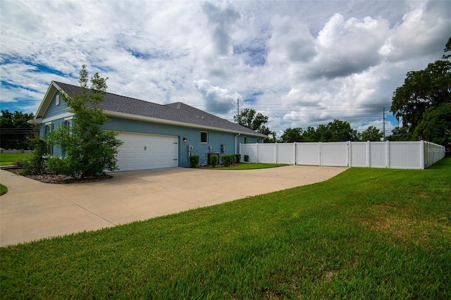 view of side of home featuring a yard and a garage