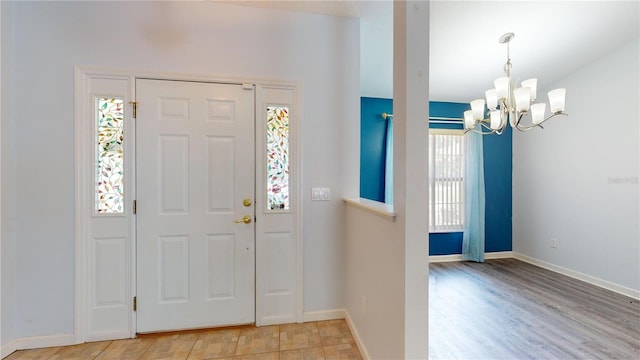 entryway featuring a notable chandelier, light hardwood / wood-style floors, and plenty of natural light