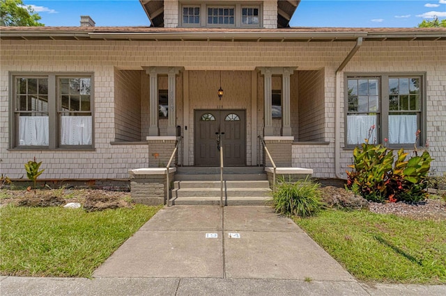 view of exterior entry with a porch