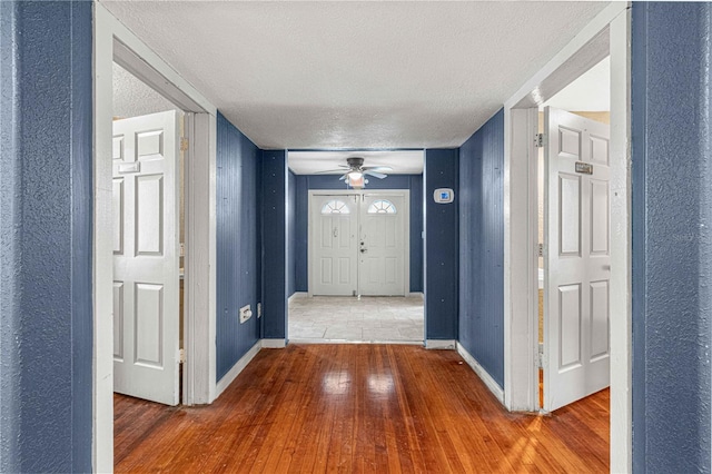 entrance foyer featuring ceiling fan, hardwood / wood-style floors, and a textured ceiling