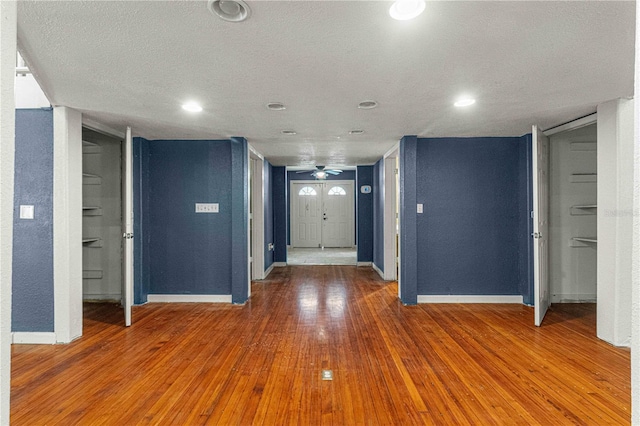 entrance foyer featuring hardwood / wood-style flooring, a textured ceiling, and ceiling fan