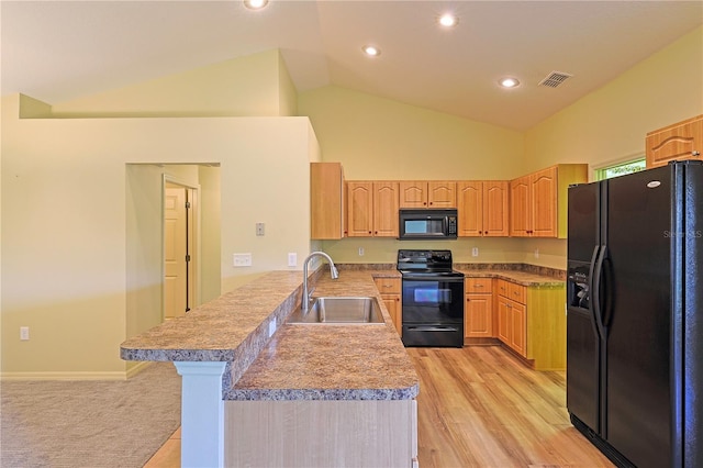 kitchen featuring sink, a kitchen breakfast bar, high vaulted ceiling, black appliances, and kitchen peninsula