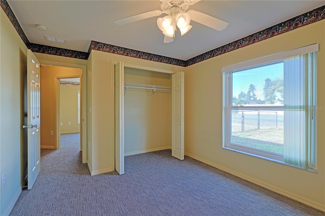 unfurnished bedroom with carpet, ceiling fan, and a closet