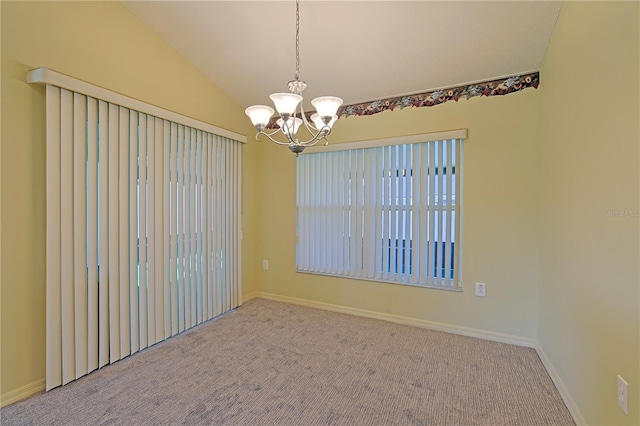 spare room with an inviting chandelier, light colored carpet, and lofted ceiling