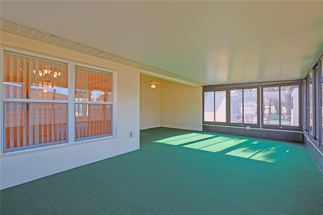 unfurnished sunroom featuring ceiling fan