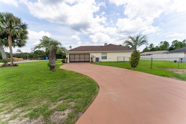 view of front of house featuring a garage and a front lawn