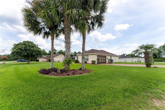 view of front of house with a garage and a front lawn