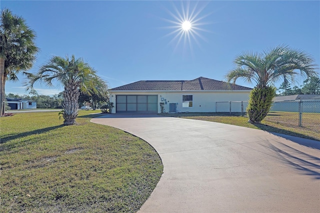 ranch-style home with a garage and a front yard