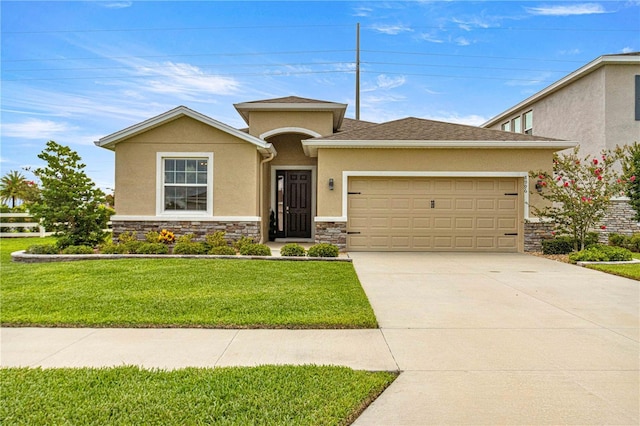 view of front of property featuring a garage and a front yard