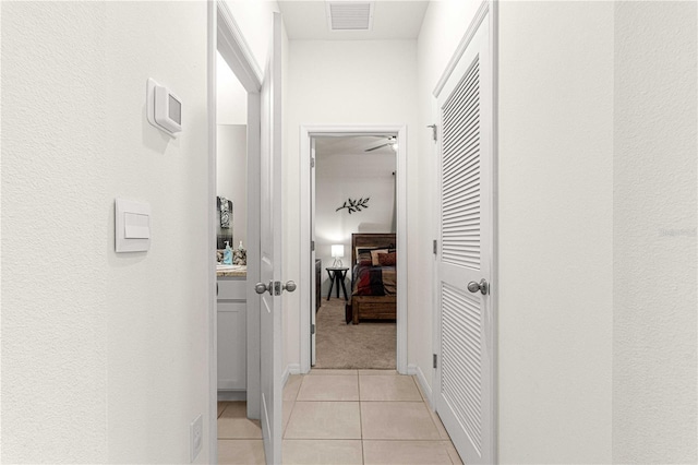 hall featuring light tile patterned flooring