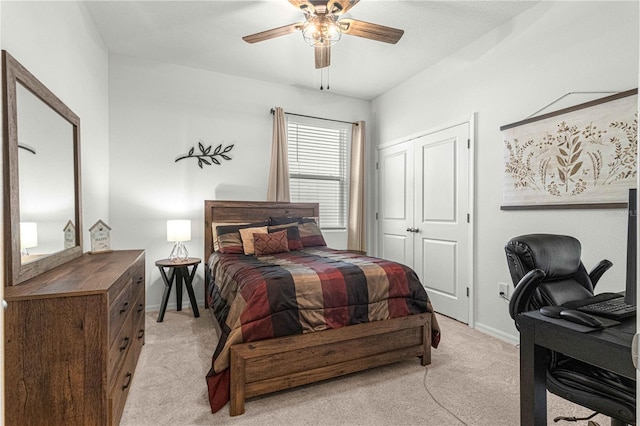 bedroom with light colored carpet, a closet, and ceiling fan