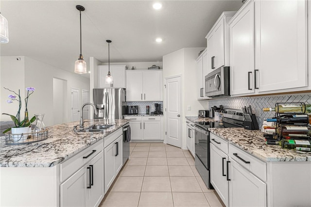 kitchen with light tile patterned flooring, sink, white cabinetry, hanging light fixtures, and appliances with stainless steel finishes