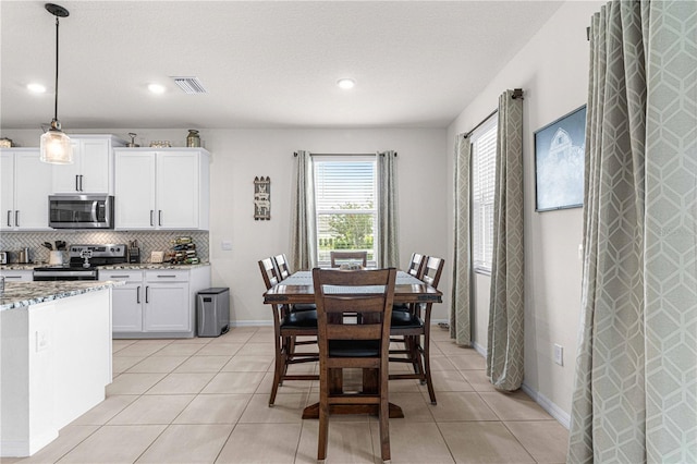 dining area featuring light tile patterned floors