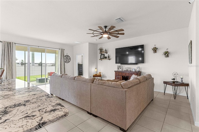 living room with ceiling fan and light tile patterned floors