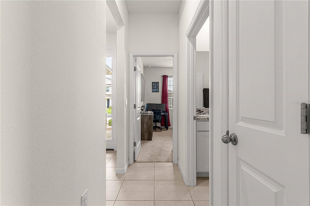 corridor featuring light tile patterned flooring