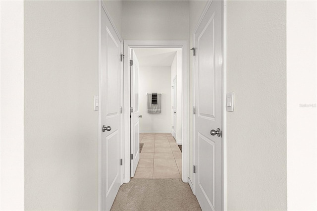 hall with light tile patterned floors