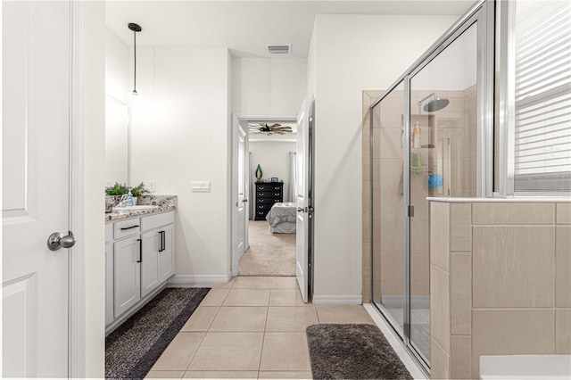 bathroom featuring vanity, tile patterned flooring, walk in shower, and ceiling fan