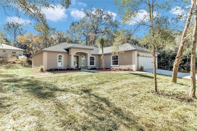 view of front of property featuring a garage and a front lawn