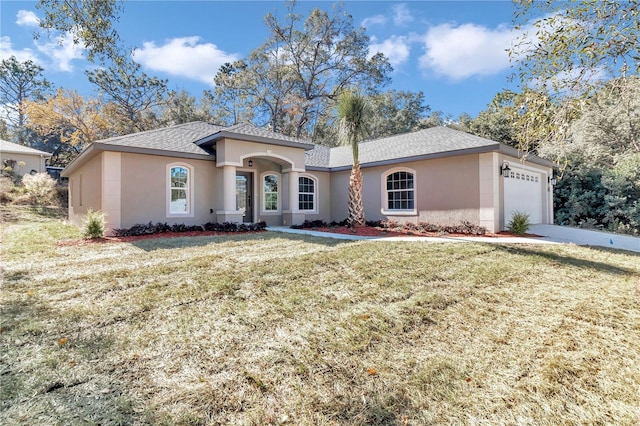 view of front of house with a front yard and a garage